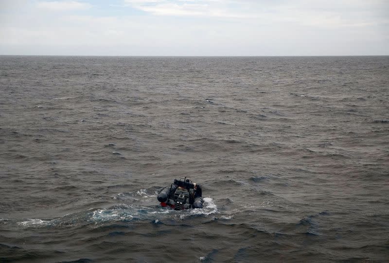 Arctic Sunrise ship crew members are seen on a rigid inflatable boat as they check for the depth in the Indian Ocean at the Saya de Malha Bank