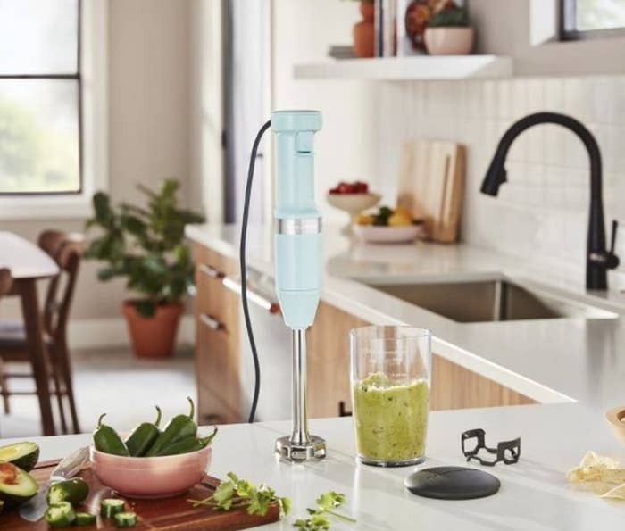 The blender on a counter with food around it