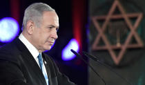 Israeli Prime Minister Benjamin Netanyahu makes his speech as he and Russian President Vladimir Putin attend an unveiling ceremony of the Remembrance Candle monument for heroes of besieged Leningrad during World War Two, in Jerusalem, Israel, Thursday, Jan. 23, 2020. Putin arrived to attend the World Holocaust Forum, which coincides with the 75th anniversary of the liberation of the Auschwitz death camp.(Aleksey Nikolskyi, Sputnik Kremlin Pool Photo via AP)