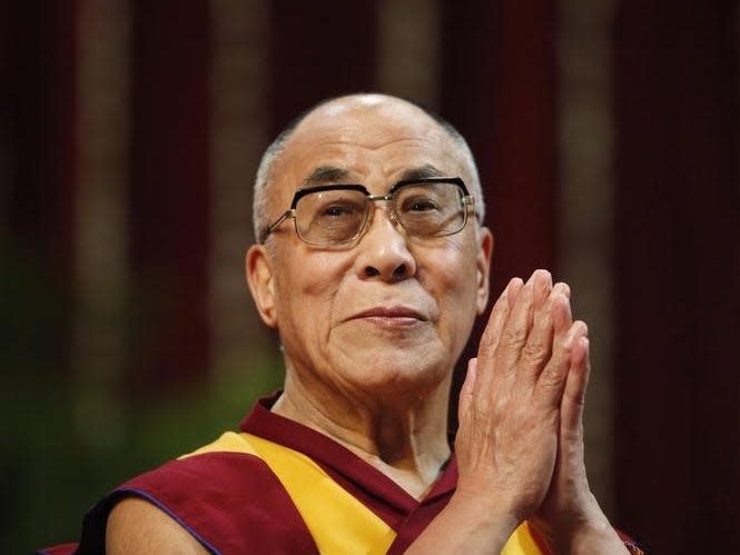 The Dalai Lama gestures before speaking to students during a talk at Mumbai University February 18, 2011. REUTERS/Danish Siddiqui 