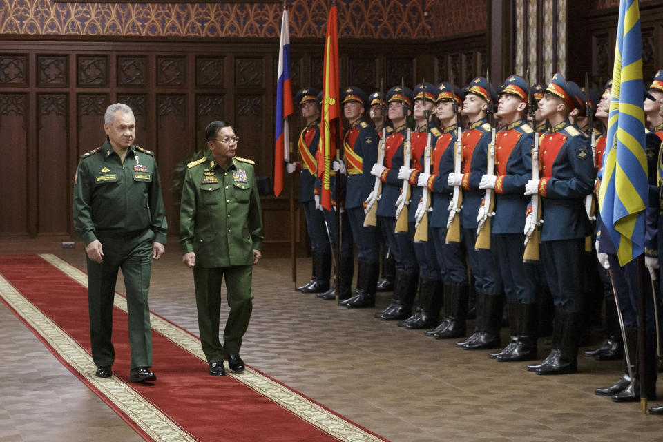 Russian Defense Minister Sergei Shoigu, left, and Commander-in-Chief of Myanmar's armed forces, Senior General Min Aung Hlaing walk past the honor guard prior to their talks in Moscow, Russia, Tuesday, June 22, 2021. (Vadim Savitskiy/Russian Defense Ministry Press Service via AP)