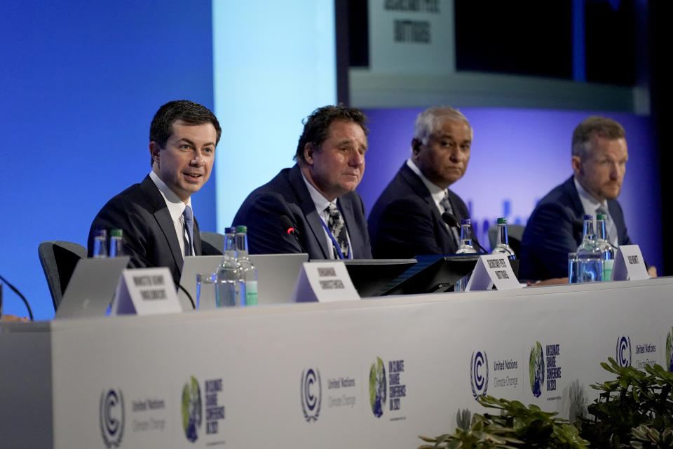 U.S. Secretary of Transportation Pete Buttigieg, left, speaks at the COP26 U.N. Climate Summit, in Glasgow, Scotland, Wednesday, Nov. 10, 2021. The U.N. climate summit in Glasgow has entered its second week as leaders from around the world, are gathering in Scotland's biggest city, to lay out their vision for addressing the common challenge of global warming. (AP Photo/Alberto Pezzali)