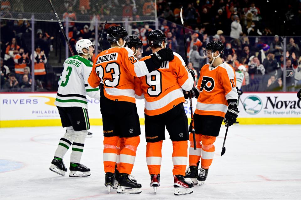 Philadelphia Flyers' Ivan Provorov (9) celebrates his goal with Oskar Lindblom (23) and Travis Konecny, right, during the second period of an NHL hockey game against the Dallas Stars, Monday, Jan. 24, 2022, in Philadelphia. (AP Photo/Derik Hamilton)