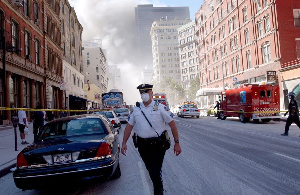 A police officer patrols in the street after the collapse of the World Trade Center towers September 11, 2001 in New York City after two airplanes slammed into the twin towers in a suspected terrorist attack (Getty Images)