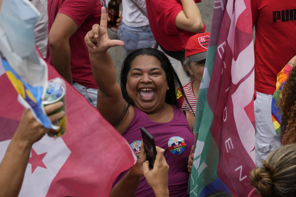 A supporter of Brazil's former President Luiz Inacio Lula da Silva, who is running for office again, flashes the letter L for "Lula" during a campaign rally with him in the Complexo do Alemao favela in Rio de Janeiro, Brazil, Wednesday, Oct. 12, 2022. The presidential run-off election is set for Oct. 30. (AP Photo/Silvia Izquierdo)