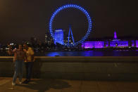 As part of the National Health Service (NH)S birthday celebrations The London Eye is illuminated blue on Saturday evening, July 4, 2020. Saturday, July 4, the day before the NHS birthday, has been designated as a opportunity for the nation to come together and pay respects. As part of this collective memorial, and as a mark of respect and tribute to NHS staff, essential workers and everyone who has played their part during the coronavirus pandemic, iconic landmarks were asked to be illuminated in blue. (Victoria Jones/PA via AP)