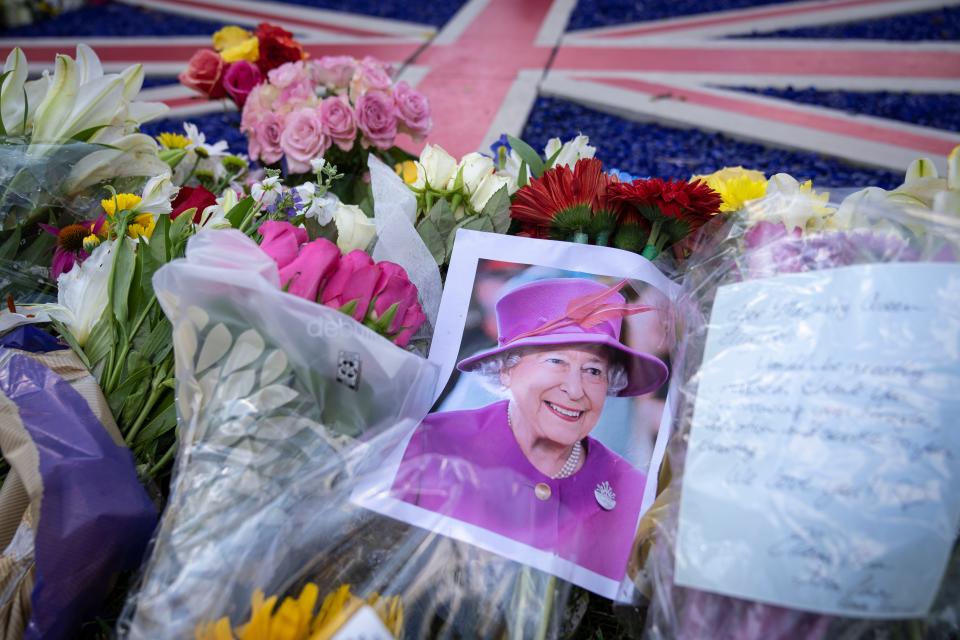 Flowers and a picture of the late Queen Elizabeth II are laid at a makeshift memorial outside the British Embassy, September 9, 2022 in Washington, DC.