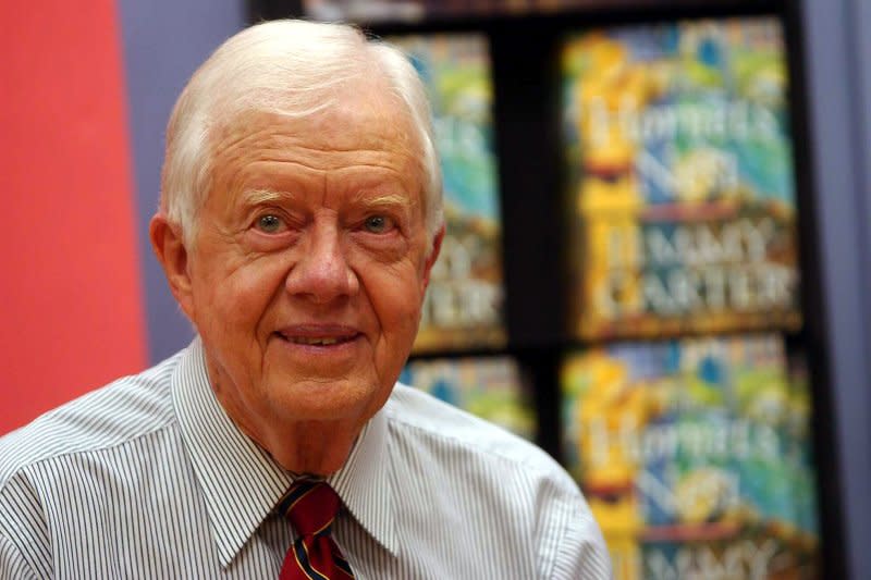 Former President Jimmy Carter poses for the media and signs books at the November 17, 2003, launch of his new fiction novel "The Hornet's Nest" at New York's Border bookstore. On May 12, 2002, Carter began a visit to Cuba. He was the first president, in or out of office, to visit the island since communists took over in 1959. UPI File Photo