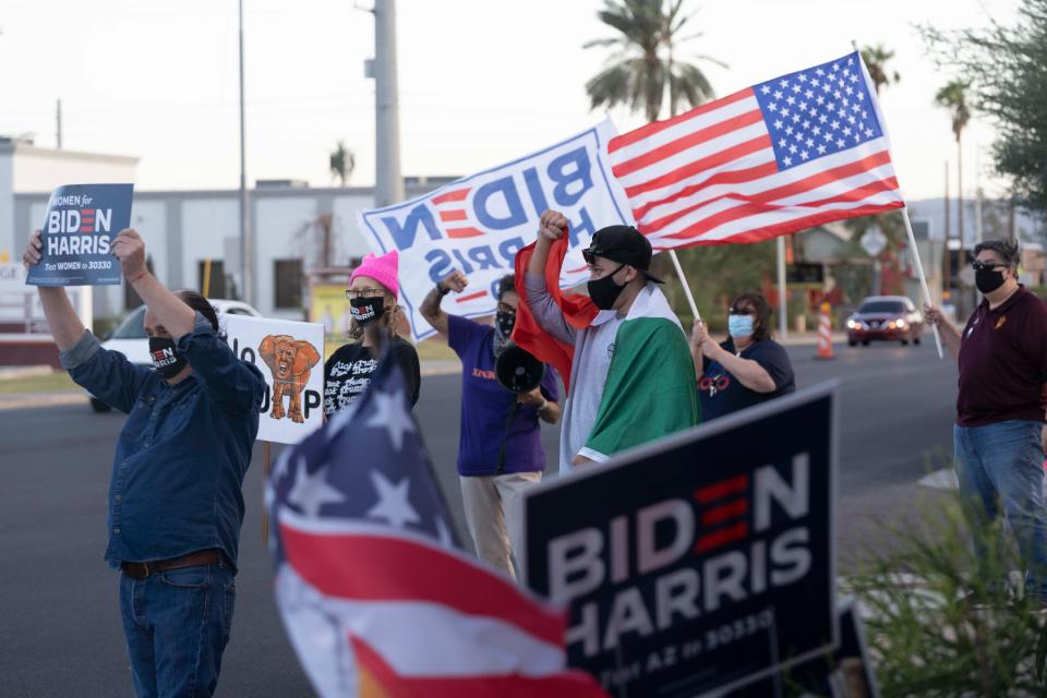 Silvana Salcido Esparza and other Biden supporters cheer while drivers honk outside Barrio Cafe in Phoenix, Arizona, Nov 7, 2020.