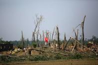 Rescue workers stand on a damaged house after a tornado hit Funing on Thursday, in Yancheng, Jiangsu province, June 25, 2016. REUTERS/Aly Song