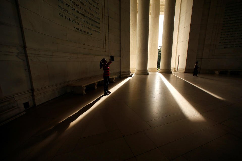 A visitor takes a photo at the Jefferson Memorial in Washington