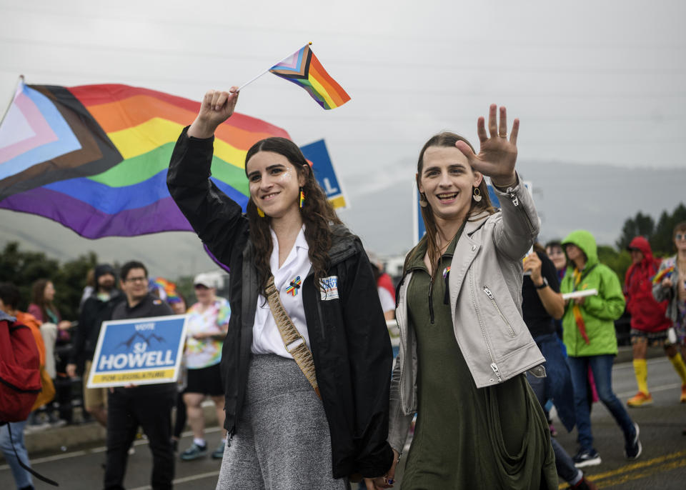 Missoula Rep. Zooey Zephyr, right, and her fiancée Erin Reed wave to supporters during the Missoula Pride Parade on Higgins Avenue on Saturday, June 17, 2023. They have emerged as a power couple offering support for the transgender community during a year in which hundreds of statehouse bills were proposed or passed to restrict their rights in health care and other realms. In the past few months they've given speeches around the country, appeared on television and in podcasts, spoke at the GLAAD awards and visited the White House. Zephyr is the first transgender female elected to the Montana Legislature. Reed circulates a policy newsletter and has amassed a following of more than 400,000 on TikTok. (Ben Allan Smith/The Missoulian via AP)