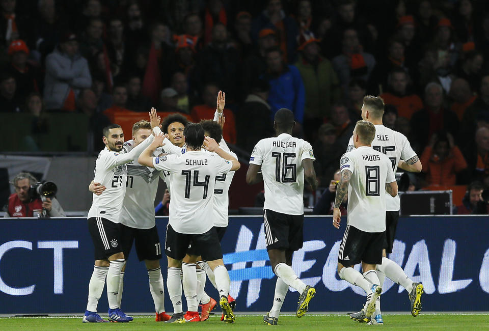 Germany's Nico Schulz, fourth from left, celebrates with his teammates after scoring his side's third goal during the Euro 2020 group C qualifying soccer match between Netherlands and Germany at the Johan Cruyff ArenA in Amsterdam, Sunday, March 24, 2019. (AP Photo/Peter Dejong)