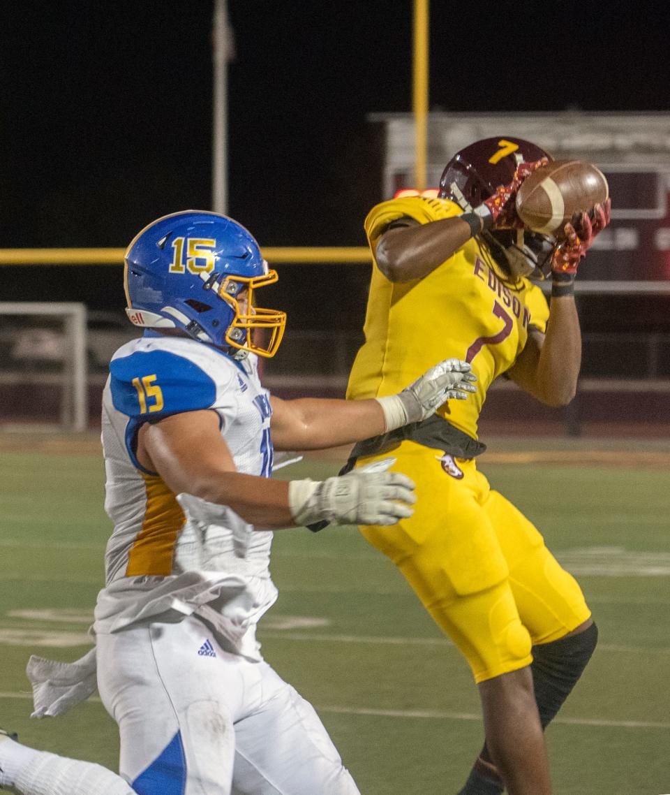 Edison's Anta'Veon McKenzie (7), right, intercepts a pass intended for Linden's Jacob Lanticse (15) during a varsity football game at Edison's Magnasco Stadium in Stockton on Friday, Oct. 14, 2022.