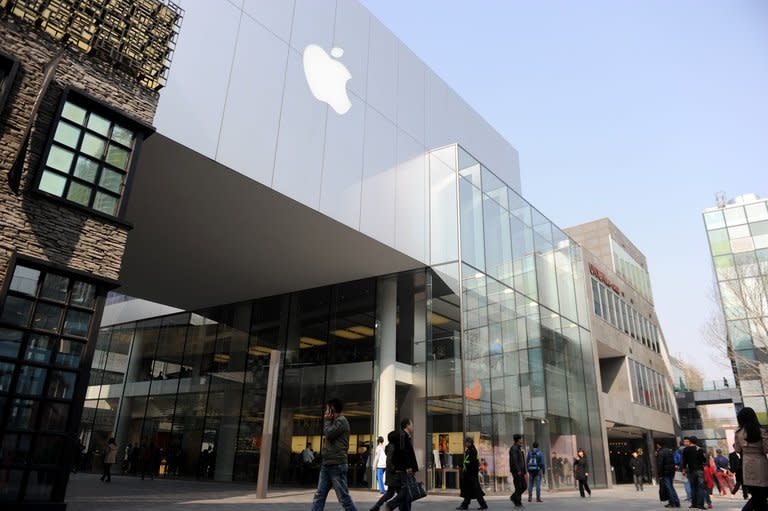 People walk past an Apple store in Beijing, on April 2, 2013. Quarterly revenue in Greater China was up 11 percent to $8.8 billion, with iPad sales more than doubling despite Apple reporting that growth had slowed there