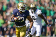 Notre Dame running back Kyren Williams (23) runs in for a touchdown in front of Purdue linebacker Jalen Graham (6) during the first half of an NCAA college football game in South Bend, Ind., Saturday, Sept. 18, 2021. (AP Photo/Michael Conroy)