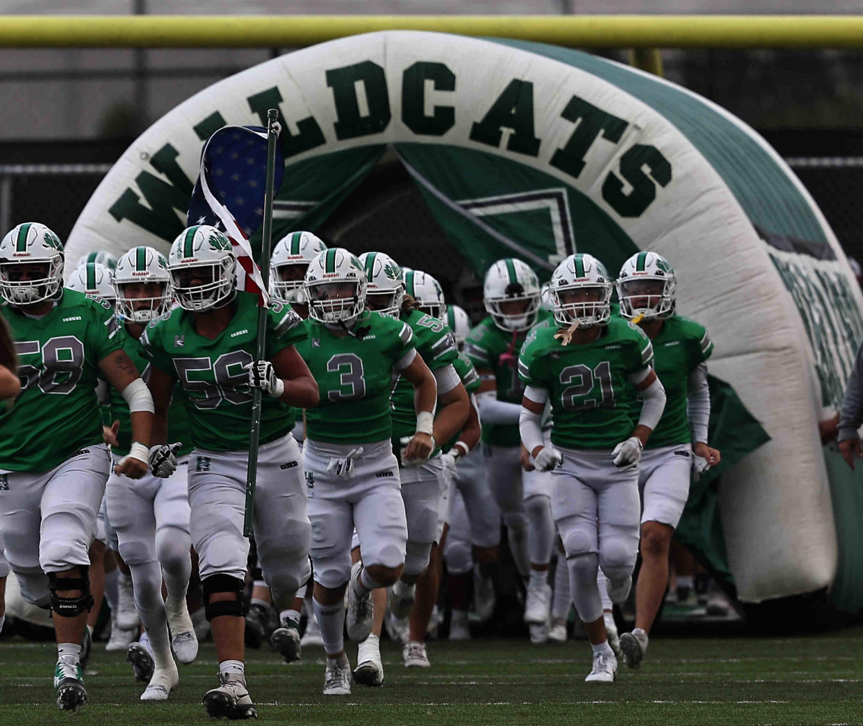 Harrison Wildcats run the field before their game against Indian Hill Friday, Sept. 6, 2024.