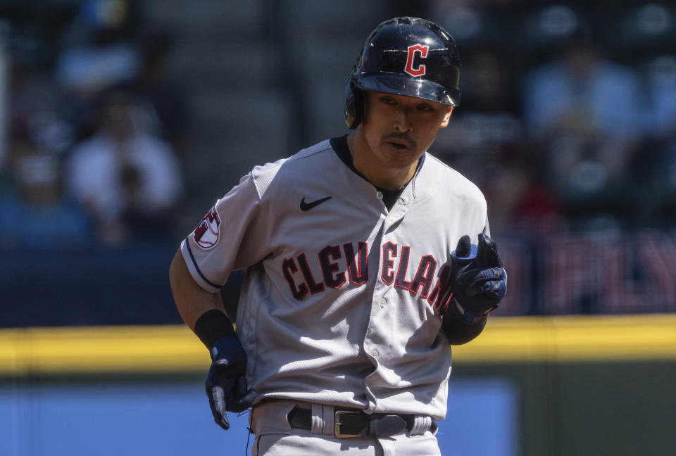 Cleveland Guardians' Steven Kwan gestures toward the dugout after hitting a double during the first inning of a baseball game against the Seattle Mariners, Thursday, Aug. 25, 2022, in Seattle. (AP Photo/Stephen Brashear)