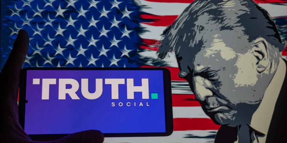 Truth Social logo displayed on a smart phone with Donald J. Trump seen in the background, in this photo illustration. On 03 September 2023 in Brussels, Belgium