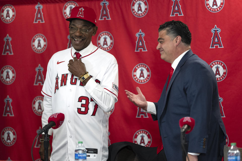 Ron Washington, left, the new manager of the Los Angeles Angels, smiles after he was presented with a jersey by general manager Perry Minasian during a news conference Wednesday, Nov. 15, 2023, in Anaheim, Calif. (AP Photo/Jae C. Hong)