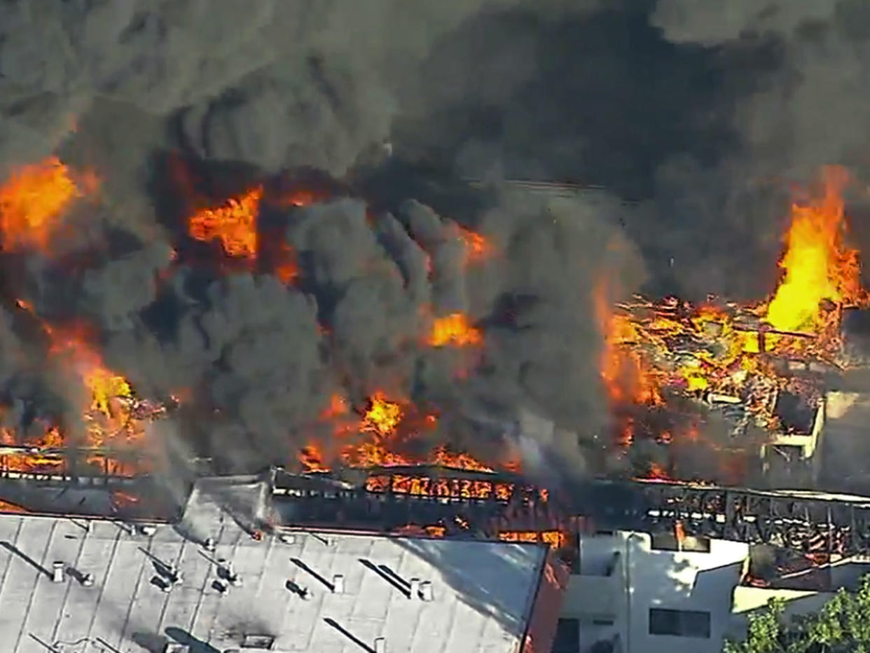 A three-alarm fire in a three-story apartment complex in Pico Rivera, California: KABC-TV via AP