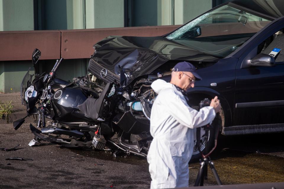 A forensic expert secures evidences on a crashed motorcycle and a car, probably the car used by an alleged offender to cause several accidents on the A 100 highway in Berlin on August 19, 2020. - A man caused a series of motorway accidents in Berlin on Tuesday night, injuring six people including three seriously in what German prosecutors have described as an Islamist act. (Photo by Odd ANDERSEN / AFP) (Photo by ODD ANDERSEN/AFP via Getty Images)