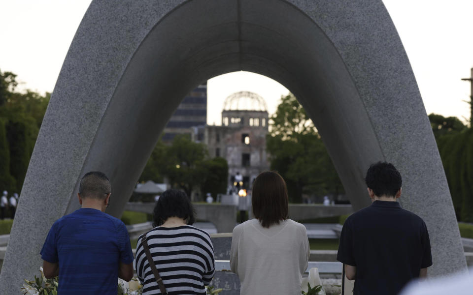 Visitors pay in front of the cenotaph dedicated to the victims of the atomic bombing at the Hiroshima Peace Memorial Park in Hiroshima, western Japan Sunday, Aug. 6, 2023. Hiroshima marked the 78th anniversary of the world's first atomic bombing of the city. (Kyodo News via AP)