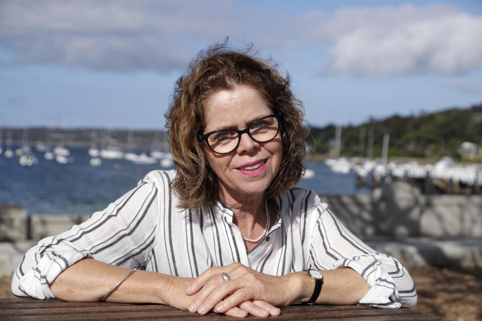 Donna Burton poses for a photo near her home in Sydney on Oct. 20, 2020. Burton had reached Sydney Airport before she was advised that Border Force had denied her an exemption to fly to London for her only daughter’s wedding in July. She had made a second application for a travel exemption after the first was rejected because of a lack of supporting documentation. (AP Photo/Rick Rycroft)