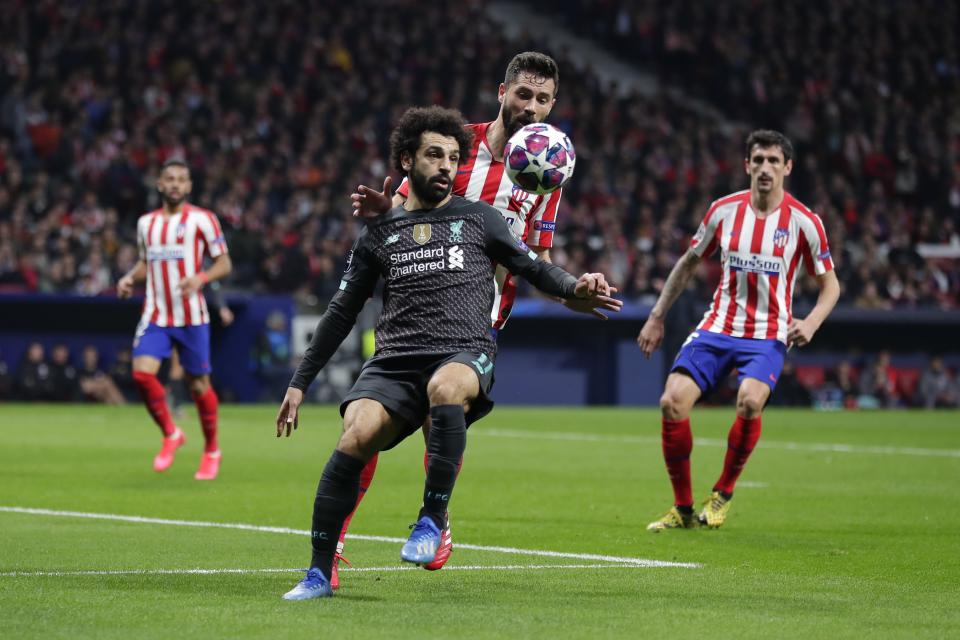 Liverpool's Mohamed Salah, foreground, controls the ball as Atletico Madrid's Felipe defends during a 1st leg, round of 16, of the Champions League soccer match between Atletico Madrid and Liverpool at the Wanda Metropolitano stadium in Madrid, Tuesday, Feb. 18, 2020. (AP Photo/Manu Fernandez)