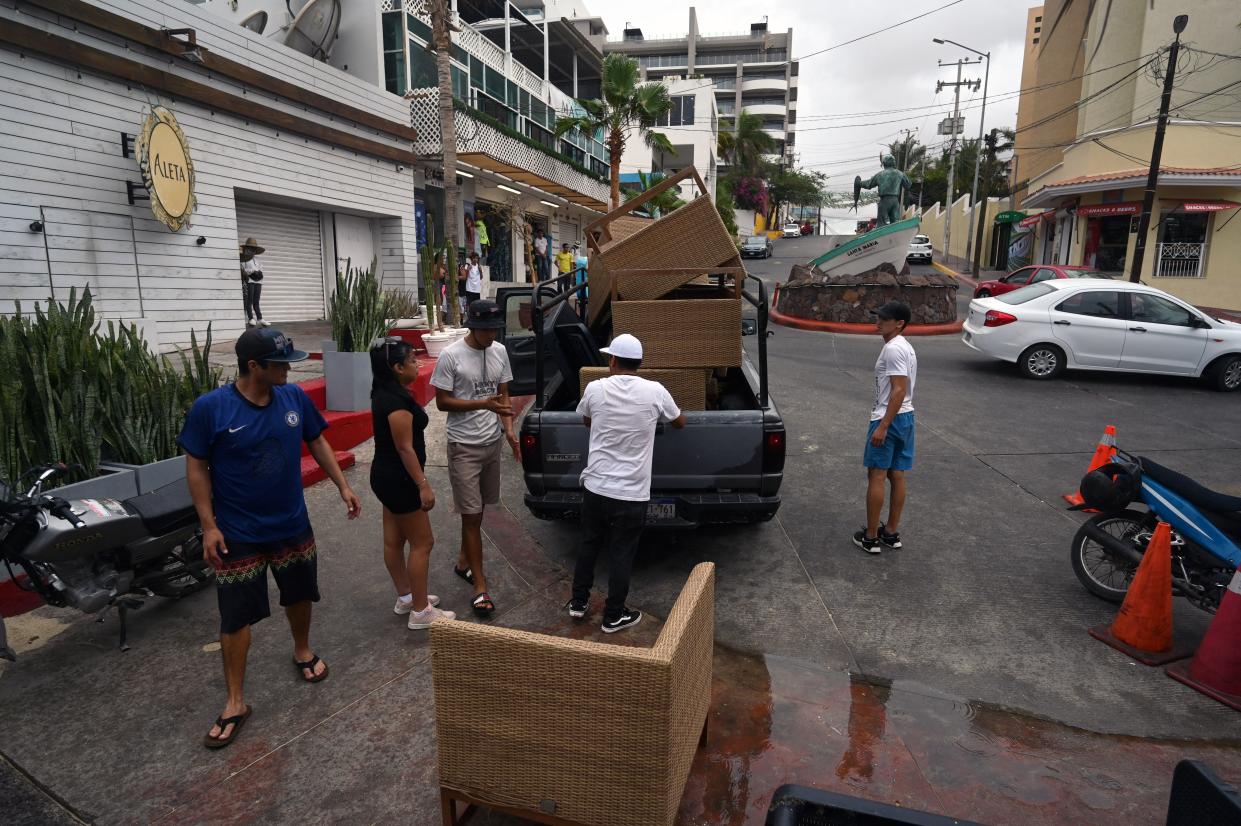 Employees of a restaurant take away the furnitures before the arrival of Hurricane Hilary at Los Cabos resort in Baja California state, Mexico on August 18, 2023. (AFP via Getty Images)