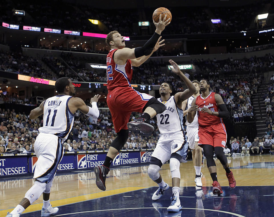 Los Angeles Clippers forward Blake Griffin (32) goes to the basket against Memphis Grizzlies guard Mike Conley (11) and forward Rudy Gay (22) in the first half of an NBA basketball game Monday, April 9, 2012, in Memphis, Tenn. (AP Photo/Lance Murphey)