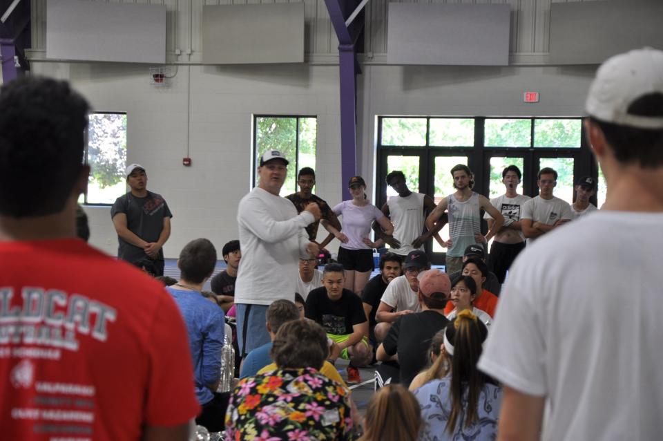 Jarrod Huntley, a visual instructor for The Bluecoats, goes over cadence information with the brass and battery unit inside Peterson Field House on May 26, 2023, at the University of Mount Union in Alliance.