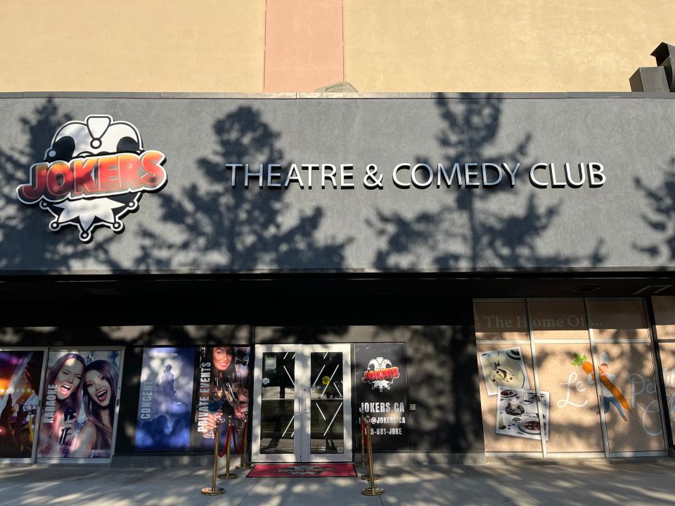 The outside of Le Petit Chef, Joker's comedy club, which is a gray and beige building