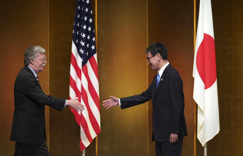 U.S. National Security Adviser John Bolton, left, and Japanese Foreign Minister Taro Kono prepare to shake hands before their meeting ahead of the G-20 summit in Osaka, western Japan, Thursday, June 27, 2019. (AP Photo/Eugene Hoshiko, Pool)