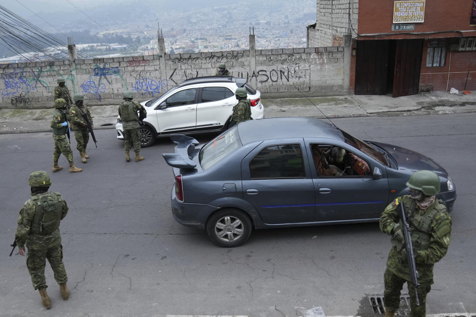 Soldiers create a checkpoint they set up in a residential area on the south side of Quito, Ecuador, Friday, Jan. 12, 2024, in the wake of the apparent escape of a powerful gang leader from prison. President Daniel Noboa decreed Monday a national state of emergency, a measure that lets authorities suspend people’s rights and mobilize the military in places like the prisons. The government also imposed a curfew from 11 p.m. to 5 a.m. (AP Photo/Dolores Ochoa)