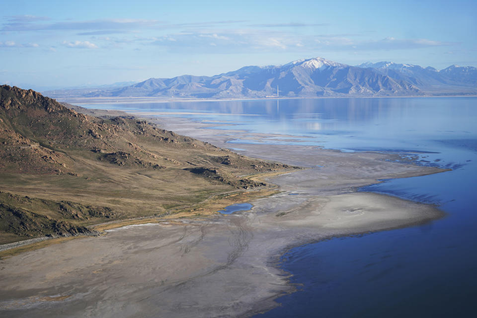 The Great Salt Lake recedes from Anthelope Island on May 4, 2021, near Salt Lake City. The lake has been shrinking for years, and a drought gripping the American West could make this year the worst yet. The receding water is already affecting nesting pelicans that are among millions of birds dependent on the largest natural lake west of the Mississippi River. (AP Photo/Rick Bowmer)
