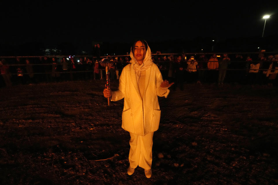 An Iranian Zoroastrian youth prays after setting a prepared pile of wood on fire during Zoroastrians ancient mid-winter Sadeh festival in outskirts of Tehran, Iran, Tuesday, Jan. 30, 2024. Hundreds of Zoroastrian minorities gathered after sunset to mark their ancient feast, creation of fire, dating back to Iran's pre-Islamic past. (AP Photo/Vahid Salemi)