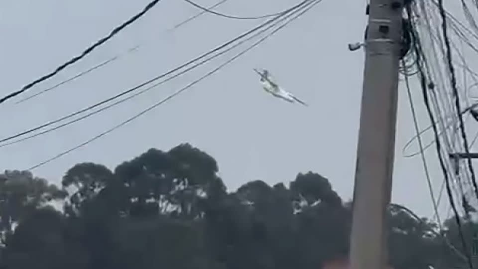 A plane is seen falling out of the sky into the city of Vinhedo, Brazil, on August 9. - Obtained by CNN