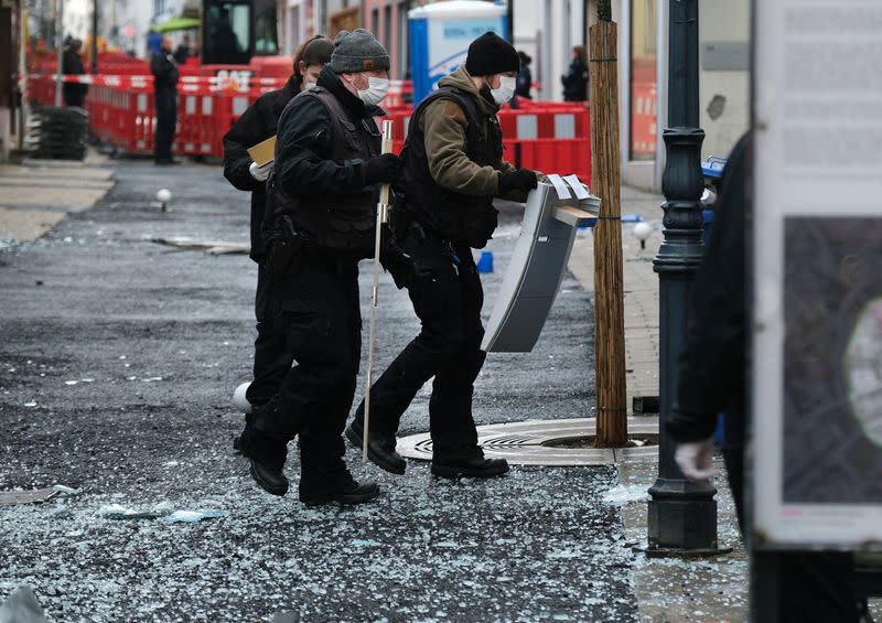 Law enforcement officers investigate the scene following an attack on bank ATMs in Ratingen