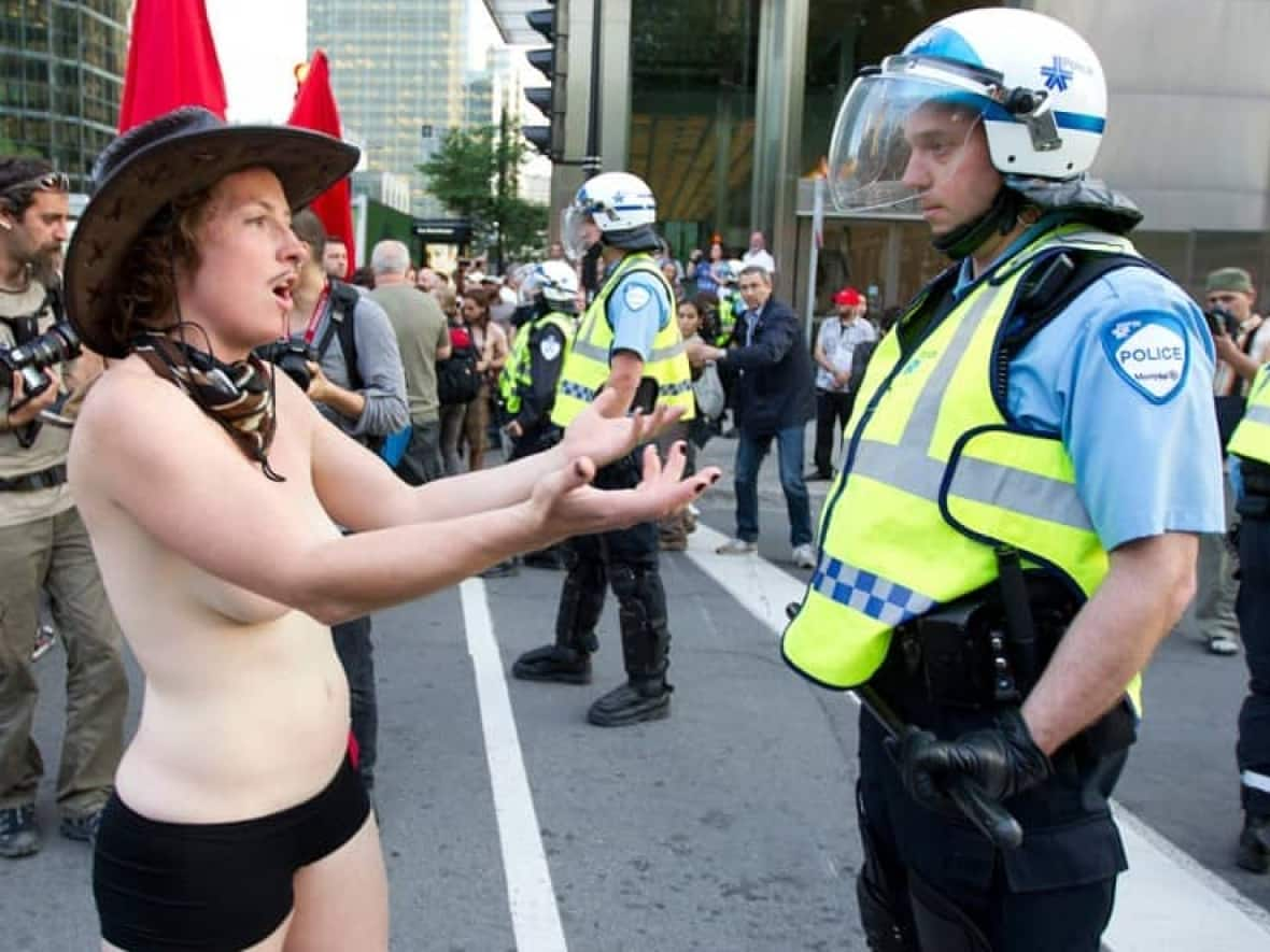 A student confronts a policeman during a demonstration in Montreal on June 7, 2012. Public nudity has been used to bring attention to a range of causes but it can also result in a criminal charge. A petition sponsored by Green MP Elizabeth May is seeking to change that. (Christinne Muschi/Reuters - image credit)