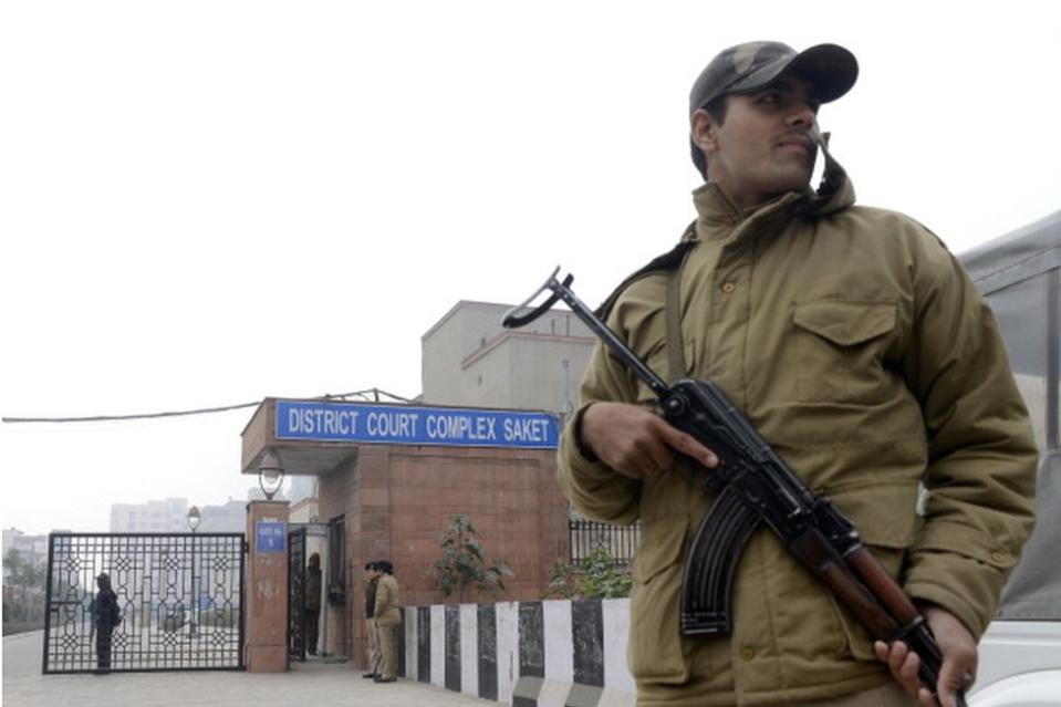 Indian policemen stand at the entrance of the Saket District Court in New Delhi on January 7, 2013.