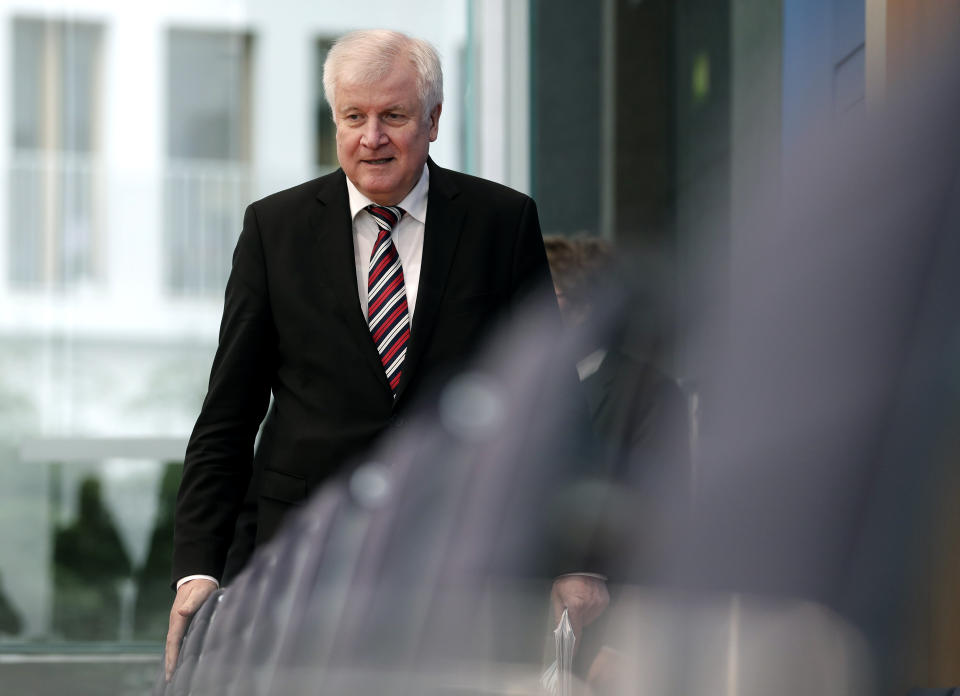 German Interior Minister Horst Seehofer arrives for the presentation of the 'Migration Report 2016/17 'during a press conference in in Berlin, Germany, Wednesday, Jan. 23, 2019. (AP Photo/Michael Sohn)