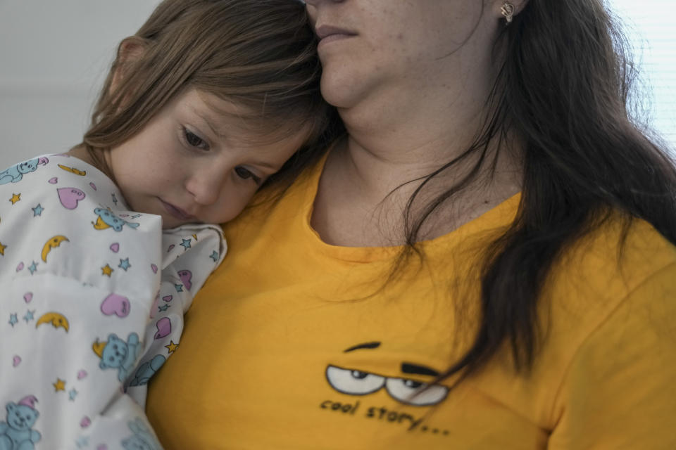 Iryna Andreiko holds her daughter Karina Andreiko, a 5-year-old Ukrainian girl, before she undergoes heart surgery by a team led by Dr. Sagi Assa, head of invasive pediatric cardiology, from the Save A Child's Heart non-profit organization, at the Wolfson Medical center in Holon, near Tel Aviv, Israel, Monday, May 2, 2022. Karina received treatment in Israel for a heart defect that she would not have in her war-ravaged home country. (AP Photo/Ariel Schalit)