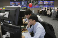 Currency traders watch monitors at the foreign exchange dealing room of the KEB Hana Bank headquarters in Seoul, South Korea, Thursday, Jan. 23, 2020. Asian shares are mostly higher as health authorities around the world move to monitor and contain a deadly virus outbreak in China and keep it from spreading globally. (AP Photo/Ahn Young-joon)