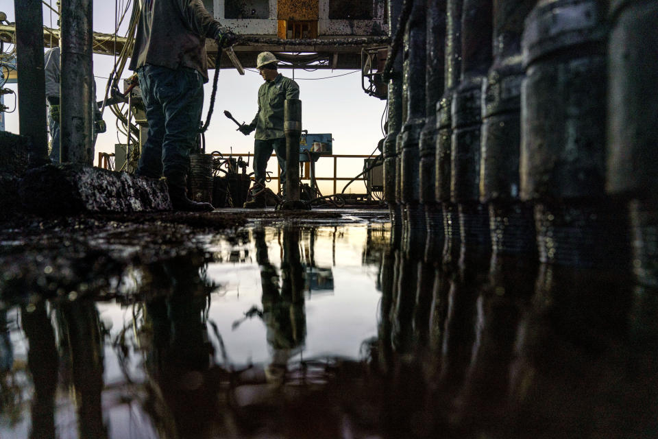 Forehand Kory Mercantel works on Latshaw drilling rig #43 in the Permian Basin in Odessa, Texas, Wednesday, Oct. 13, 2021. The Permian is the top oil and gas producing region in the United States. On any given day, about 500 rigs are drilling new wells within the basin to boost production. (AP Photo/David Goldman)