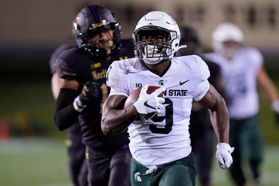 Michigan State running back Kenneth Walker III (9) runs for a touchdown past Northwestern safety Brandon Joseph (16) during the first half of last season's game in Evanston, Ill. Like Walker, Jacoby Windmon joined MSU as a transfer. And like Walker, Windmon had a game for the ages in his debut.