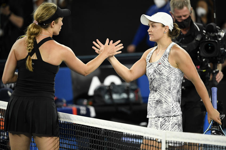 Ash Barty, right, of Australia is congratulated by Danielle Collins of the U.S., after winning the women's singles final at the Australian Open tennis championships in Saturday, Jan. 29, 2022, in Melbourne, Australia. (AP Photo/Andy Brownbill)