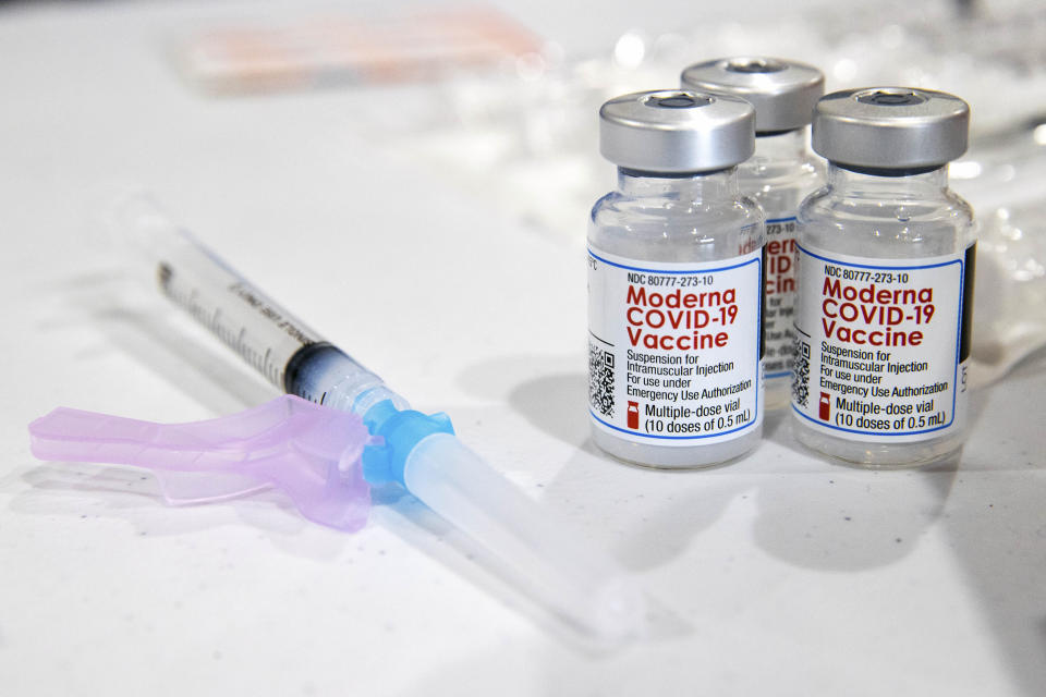 Vials of the Moderna COVID-19 vaccine are placed next to a loaded syringe at the Throop Civic Center in Throop, Pa. during a clinic on Saturday, Jan. 9, 2021. The Lackawanna County Medical Society had about 400 doses of the Moderna vaccine on hand to administer to those in the Phase 1A group of Pennsylvania's vaccine rollout plan, which is limited to healthcare personnel and long-term care facility residents. (Christopher Dolan/The Times-Tribune via AP)