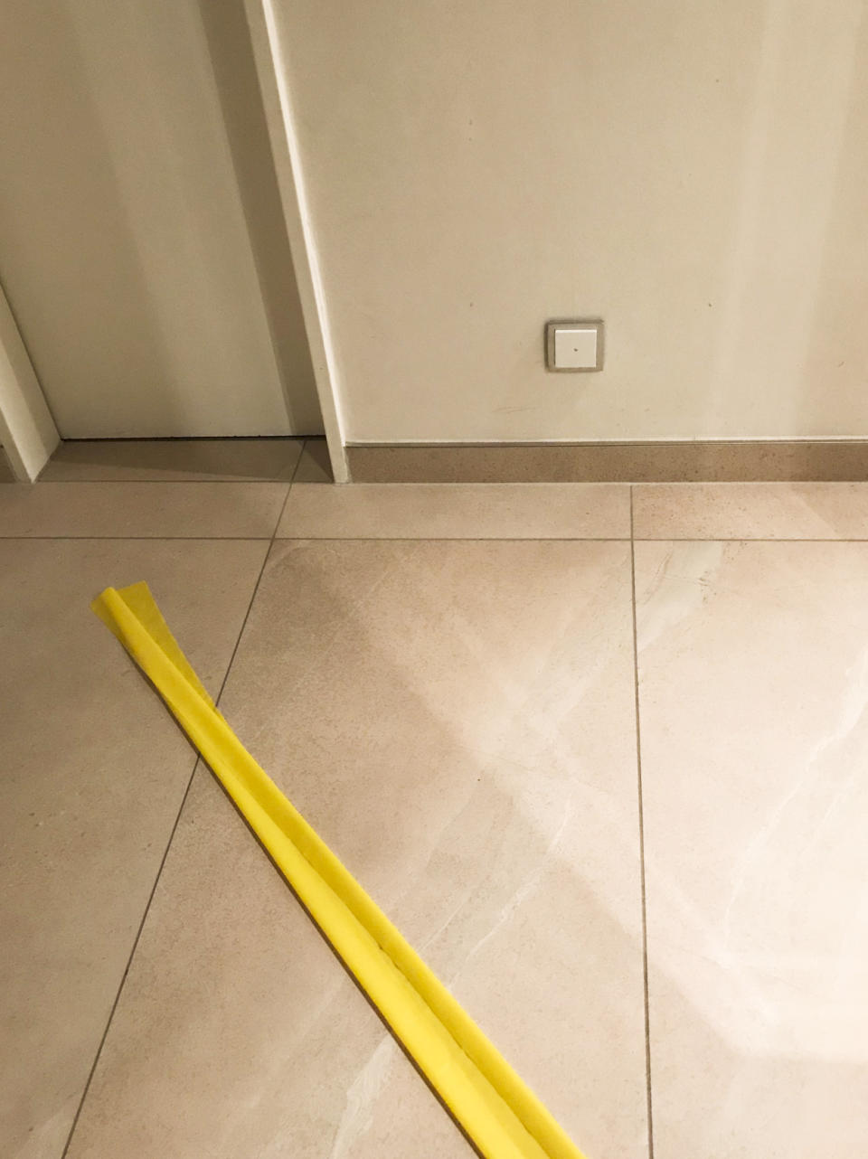 This photo taken on March 12, 2020 shows a yellow tape placed on the floor by the children of Karoline Preisler, to separate their home in Barth, Germany into areas for infected and non-infected persons of COVID-19 respiratory disease. Lonely, frightened and unwell, Preisler turned to the internet for information from other patients but didn’t find many first-hand accounts of living with and fighting the virus. So she decided to share her experience on Twitter. (Karoline Preisler via AP)