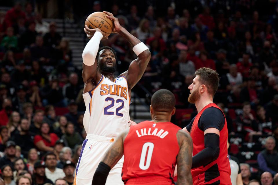 Oct 21, 2022; Portland, Oregon, USA; Phoenix Suns center Deandre Ayton (22) shoots a jump shot over Portland Trail Blazers center Jusuf Nurkic (27) during the first half at Moda Center.